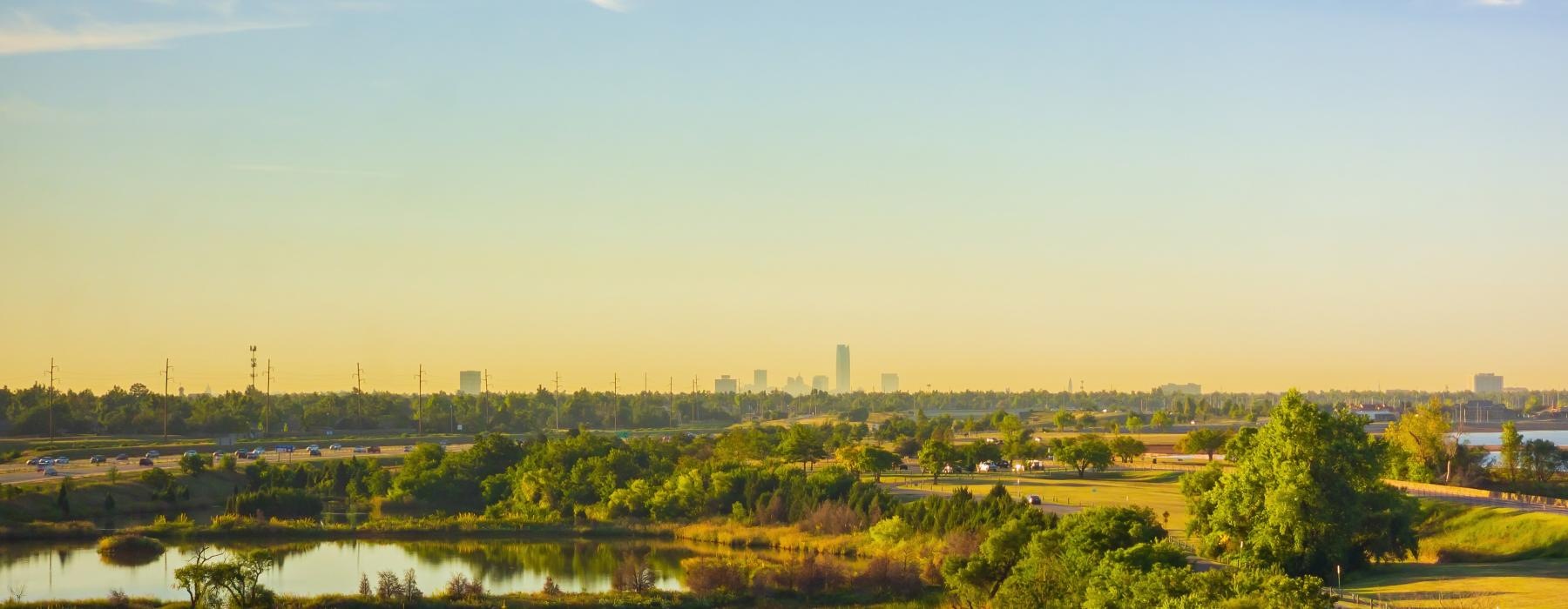 a body of water with trees and buildings in the background