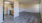 a large empty room with wood-style flooring
