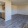 a large empty room with wood-style flooring