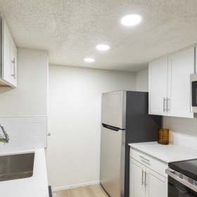 white cabinets stainless and black appliances